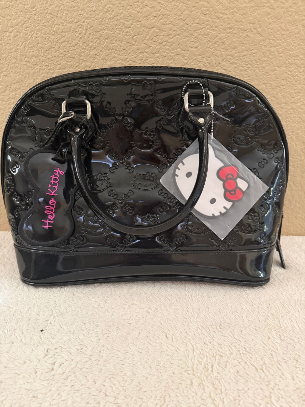 Hello Kitty Black Patent Embossed Handbag with Bow Logo, Tags, and dust bag